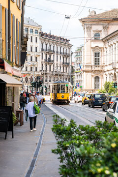 Milan. Italy - May 21, 2019: Old Yellow MIlan Tram. Street Panorama with Pedestrians and Cars on a Sunny Day.