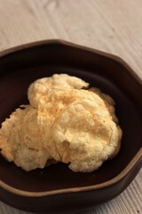 Emping Melinjo is Indonesian Traditional Crackers in a Brown Bowl, made from Melinjo or Belinjo (Gnetum gnemon) Nut