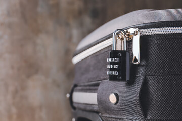 Suitcase with lock on grey background, closeup