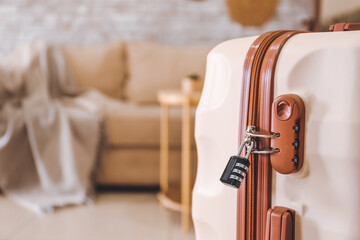 Suitcase with lock in room, closeup
