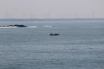 Long view of Boat and wind mill at Kanya kumari Bay of Bengal