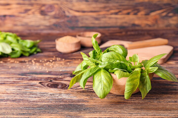 Fresh green basil on wooden table