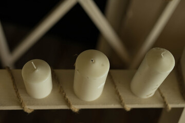 wax candles stand on a shelf