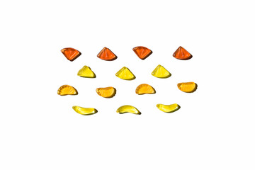 Colorful jelly beans in fruits shapes. Top view of positive and sweet composition on white background.