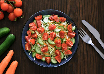 Cucumbers, tomatoes, cabbage and carrot salad.  Vegetable salad.  Healthy and dietary food concept. 