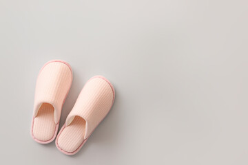 Pair of soft slippers on light background