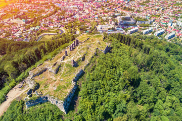 Panoramic view of Ruins of Khust Castle on the mount and mountain valley with Khust city. View from above. Zakarpattia Oblast, Ukraine, Europe