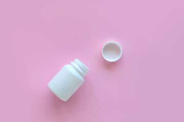 White pill packaging on pink background. Tablets. Close-up.