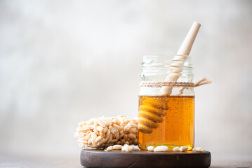 jar of fresh linden honey and a honey spoon