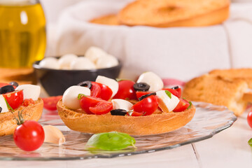 Friselle with tomatoes and mozzarella cheese.
