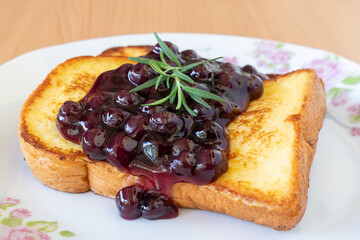 Homemade French toasts with blueberries on a plate.