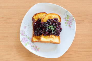 Homemade French toasts with blueberries on a plate.