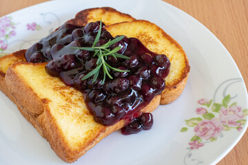 Homemade French toasts with blueberries on a plate.