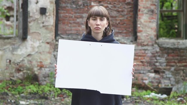 Young Millenial Woman Holding blank card board sign