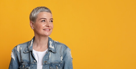 Thoughtful Beautiful Middle-Aged Lady Looking At Copy Space On Yellow Background