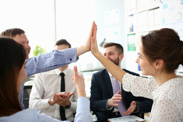 Group of joyful smiling happy people celebrate win with arms up. Mediation offer high five...