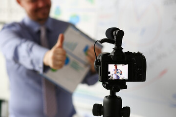 Male in suit and tie show confirm sign arm making promo videoblog or photo session in office...