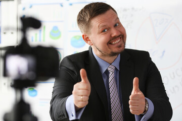 Male in suit and tie show confirm sign arm making promo videoblog or photo session in office...