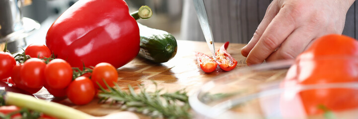 Chef Hands Cutting Red Hot Chili Pepper Halves. Assorted Vegetables on Wooden Board. Male Cooking Dieting Salad. Natural Vegetarian Aromatic Ingredient. recipe of Delicious Dish Horizontal Photo