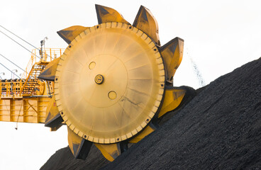 Coal mining rotating buckets sorting and moving the coal into stacks, on a isolated white...