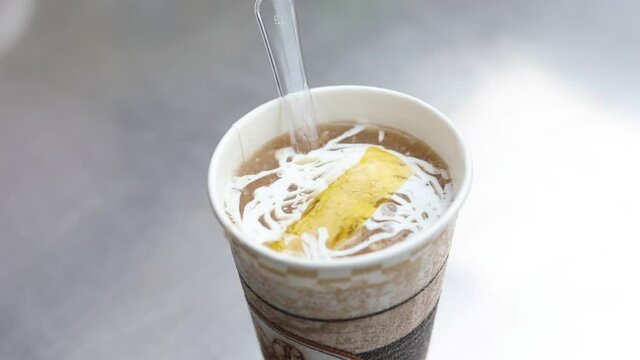 Butter melting over a cup of chicken soup. Sunny chicken Soup, New Delhi.