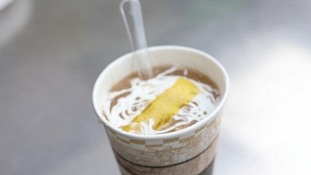 Butter melting over a cup of chicken soup. Sunny chicken Soup, New Delhi.