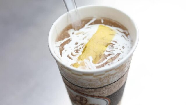 Butter melting over a cup of chicken soup. Sunny chicken Soup, New Delhi.