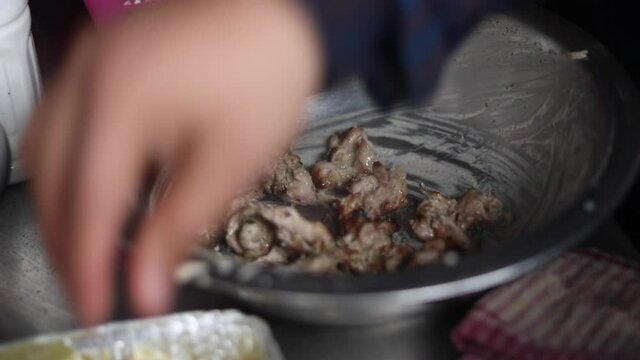 Marinating chicken malai tikka in butter and cream. 