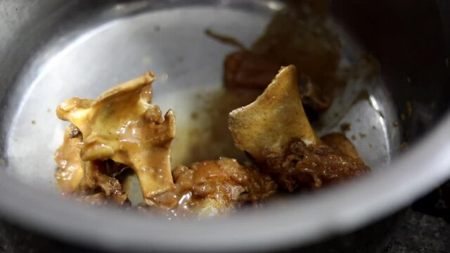 Pieces of mutton or nihari in a steel pot.