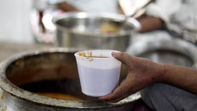 Packing nihari gravy in a plastic box. White packaging box.
