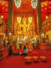 view of Giant Golden Buddha Statue in buddhist temple, Lanna Style Art 13th. Century. Wat Phra That Haripunchai Woramahawihan, Lamphun Province, northern of Thailand.
