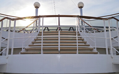 Empty staircase or stairs on cruiseship or cruise ship liner with metal railing and wooden handrail...