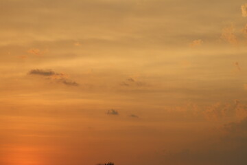 sky at the time of sunset with yellow and orange coloured clouds