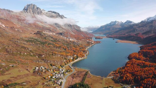 4K aerial - a bird's eye view&nbsp;video (Ultra High Definition).  Sunny autumn view of Sils lake. Wonderful morning scene of Swiss Alps. Aerial outdoor scene of Maloya village, Switzerland, Europe.