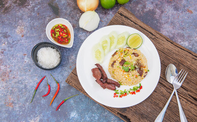 Thai food : Close up Fried rice with salted beef on white plate Served with Cucumber, and Lime, healthy food,
