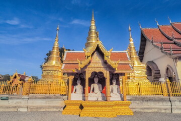 view of Golden Pagoda (Stupa, Chedi) with buddhist temple lanna style art and blue sky background, Wat Phra That Ha Duang, Li District, Lamphun, northern of Thailand.