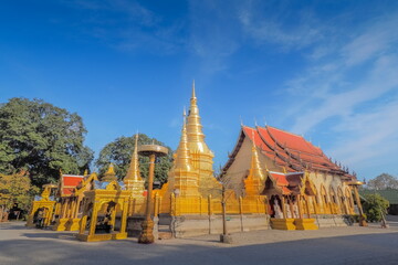 view of Golden Pagoda (Stupa, Chedi) with buddhist temple lanna style art and blue sky background, Wat Phra That Ha Duang, Li District, Lamphun, northern of Thailand.