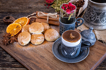 Coffee in a traditional mug and coffee beans on the wooden table