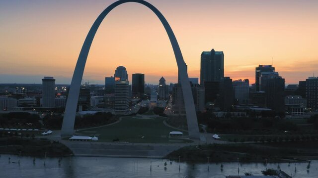 Aerial: The Gateway Arch, Mississippi River & downtown St Louis at sunset, Missouri, USA