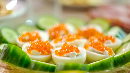 Eggs stuffed with caviar blurred background. festive kitchen to the table