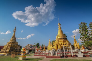 Fototapeta premium view of Golden Pagoda Shan or Myanmar style art 18th. Century. with blue sky background, Jong Soong Pagoda, Wat Jong Soong, Mae Sariang, Mae Hong Son, northern of Thailand.