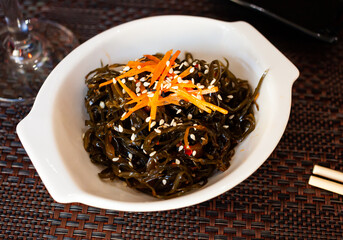 Seaweed salad in white bowl