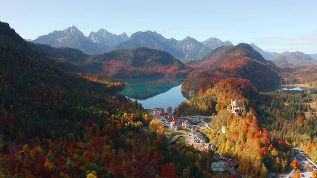 4k drone forward video (Ultra High Definition). Amazing autumn view of Alterschrofen village in Fussen Germany. Sunny morning scene of Bavarian Alps, Germany, Europe. Traveling concept background.