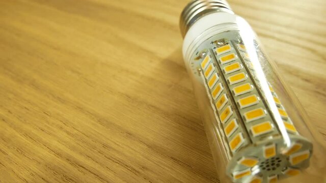 The disassembled LED corn lamp is on the table. Base E27