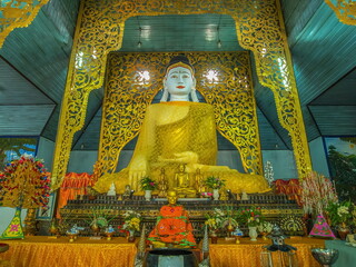 view of marble buddha statue wearing traditional custume in buddhist temple, Wat Chong Kham, Mae Hong Son, northern of Thailand.