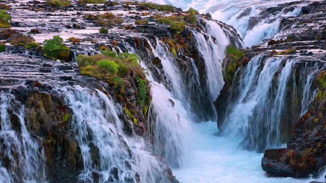 Spectacular summer view of Bruarfoss Waterfall, secluded spot with cascading blue waters. Superb sunrise in Iceland, Europe. Beauty of nature concept background. Full HD video (High Definition).
