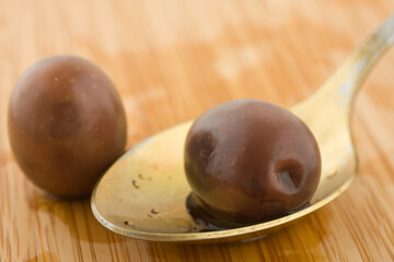 black olives in a spoon against