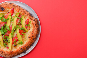 Close-up of a delicious smoked salmon pizza with cheese, avocado and smoked salmon. Sea-food. Bright red background.