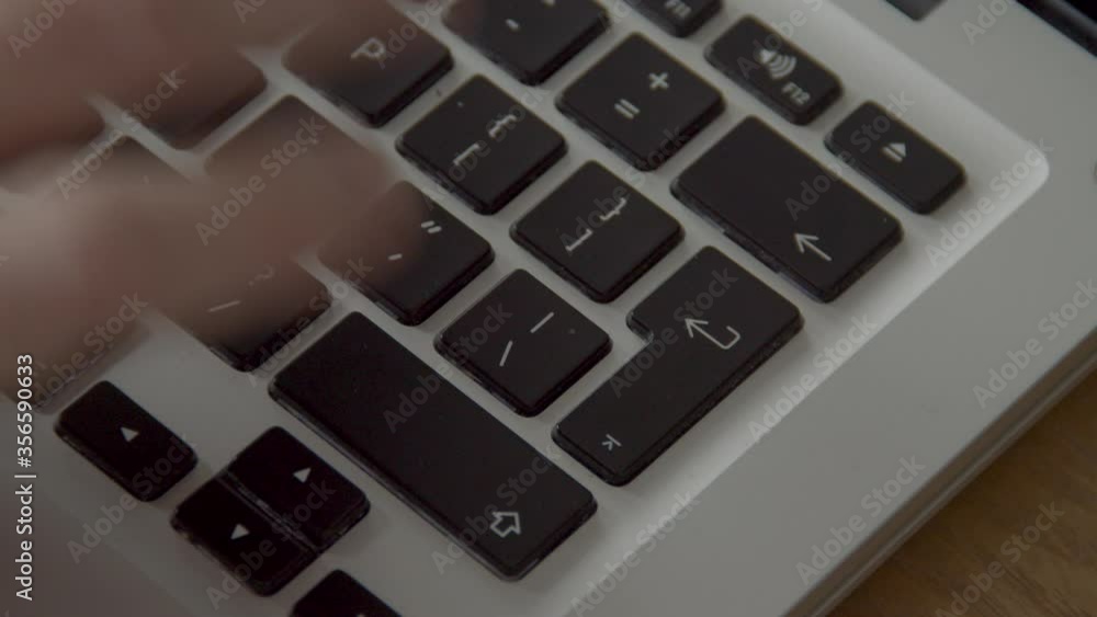 Poster finger pressing the enter button on laptop keyboard several times while typing