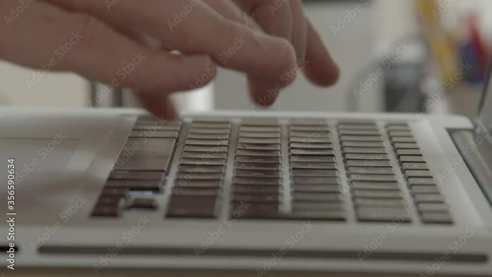 Poster hands quickly typing on laptop keyboard and switching to using fingers only